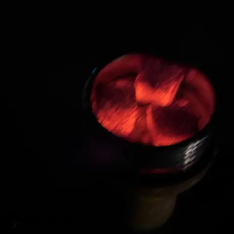 Glowing coals in a shisha bowl.